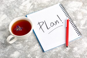 Planning notes for an interior demolition process with notebook and pen on a workspace